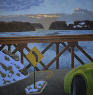 A yellow turn-left road sign stands on a snowy bridge overlooking a body of water at dusk.