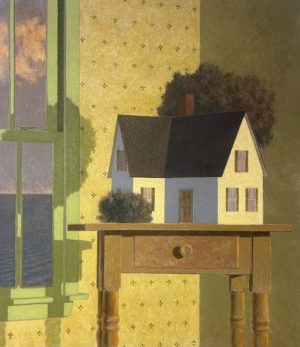 A dollhouse sits on a wooden side table in a room beside a window overlooking the sea.